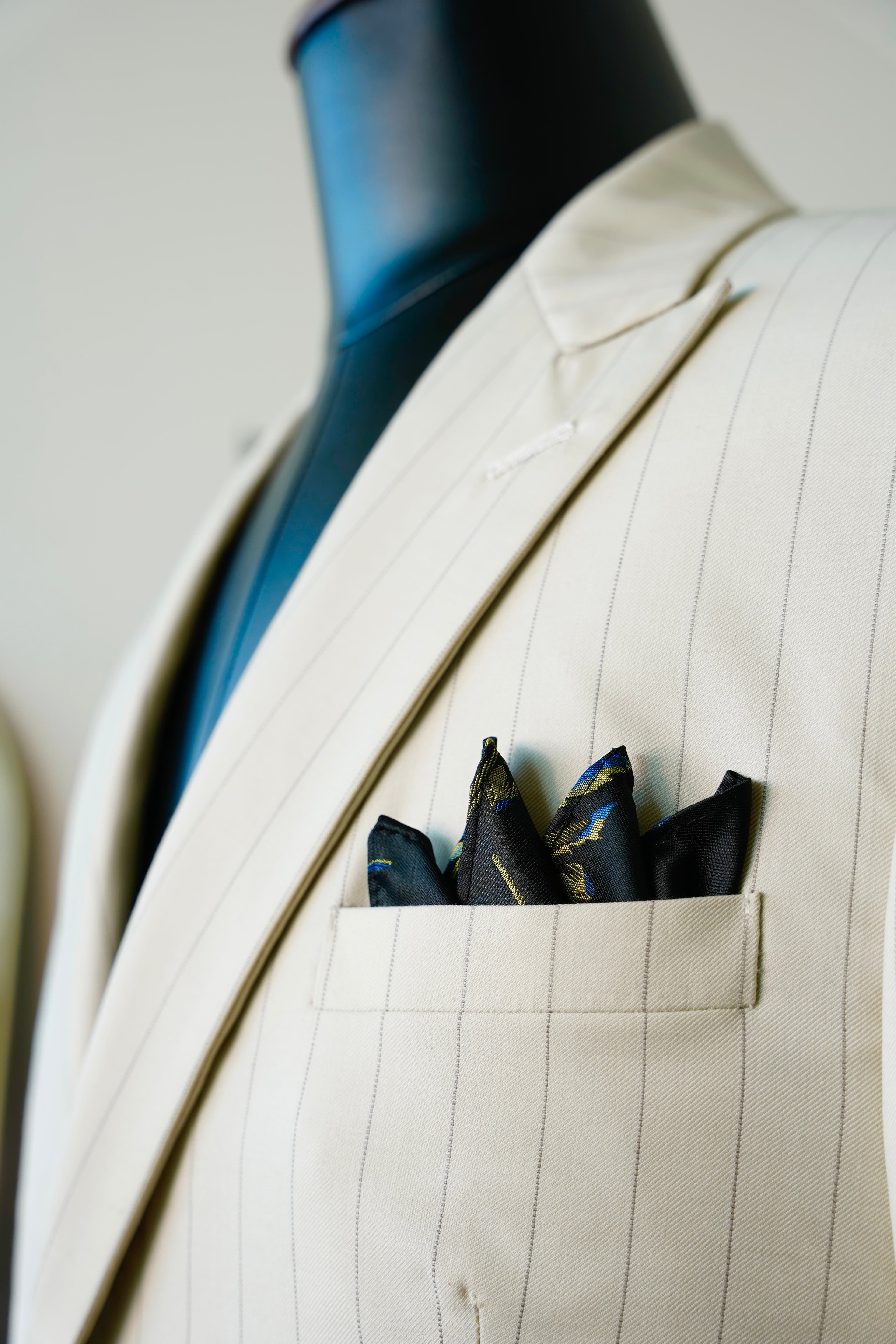 Cream pinstripe suit detail with silk pocket square